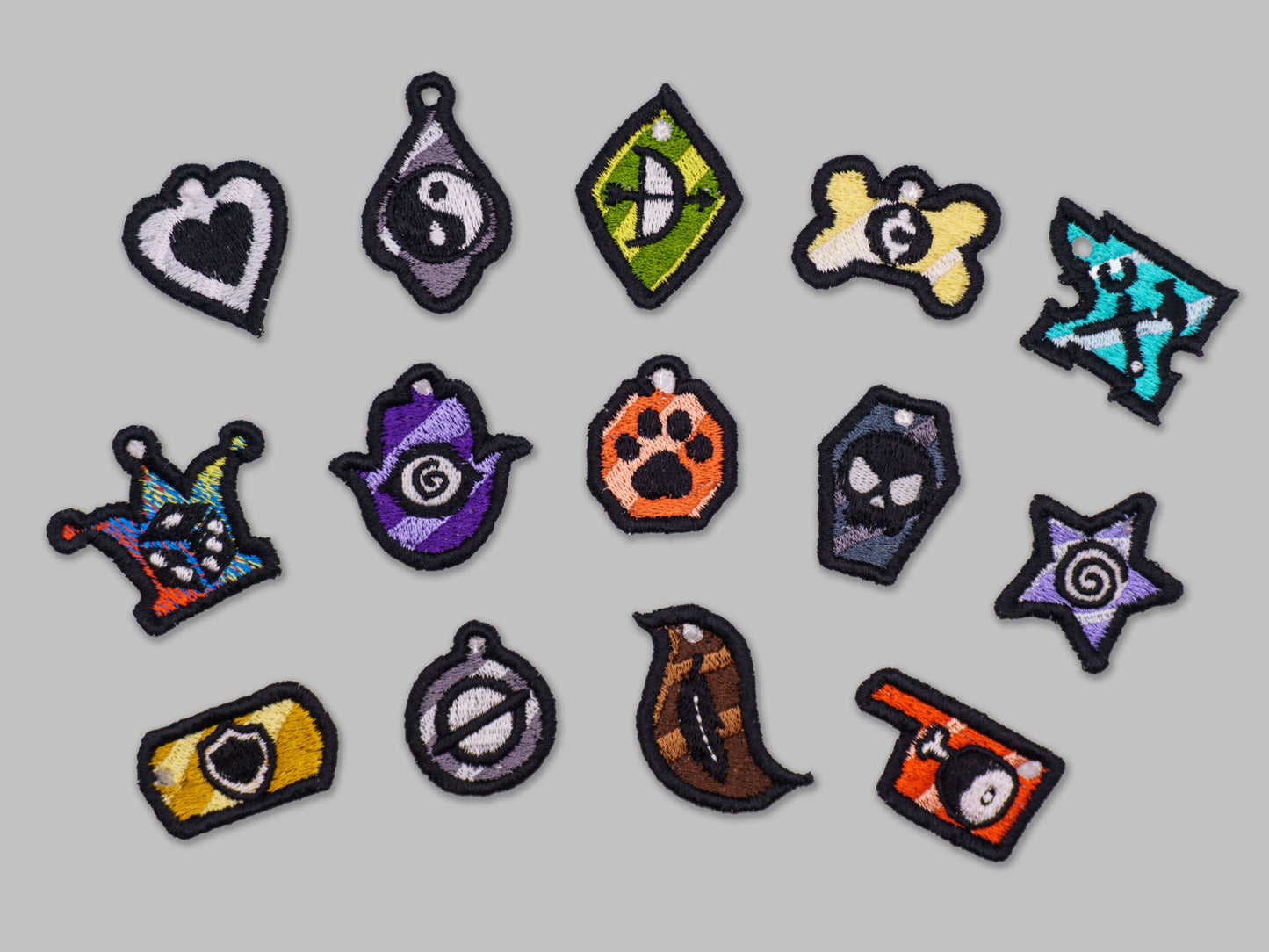 Collection of colorful embroidered patches on a gray background