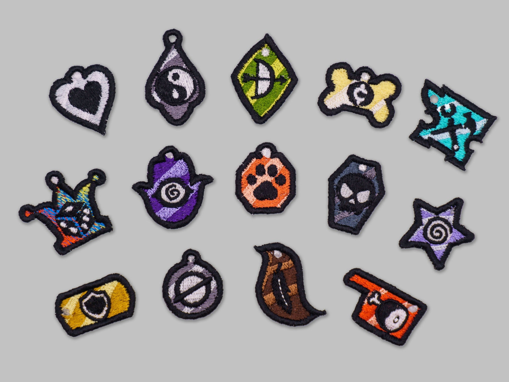 Collection of colorful embroidered patches on a gray background