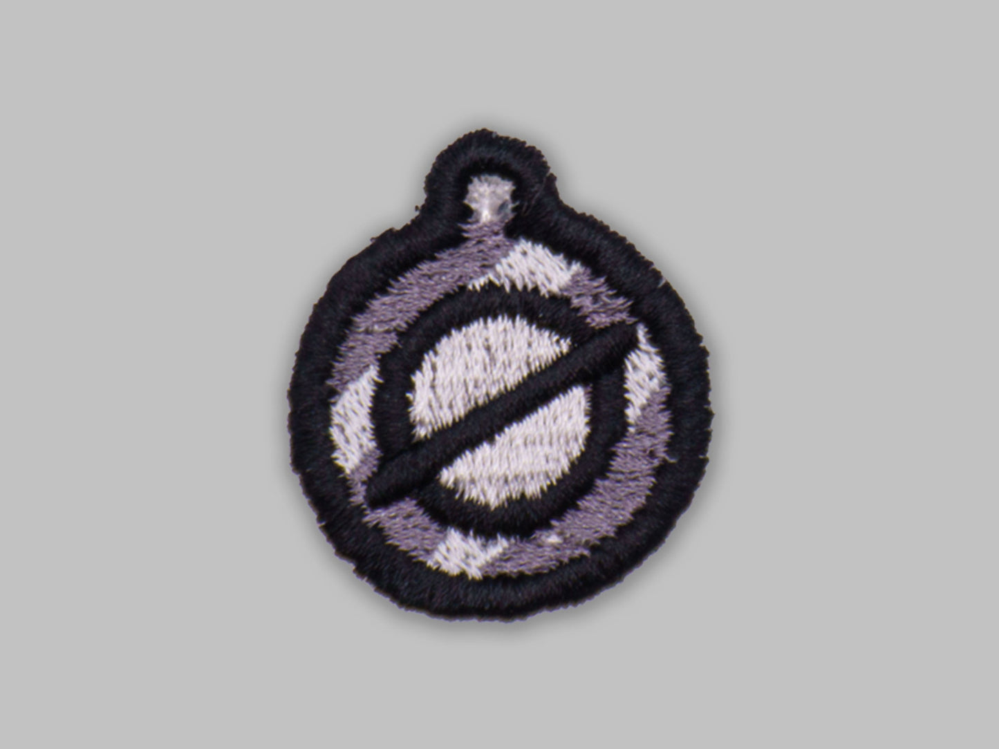 Circular patch with a design on a gray background