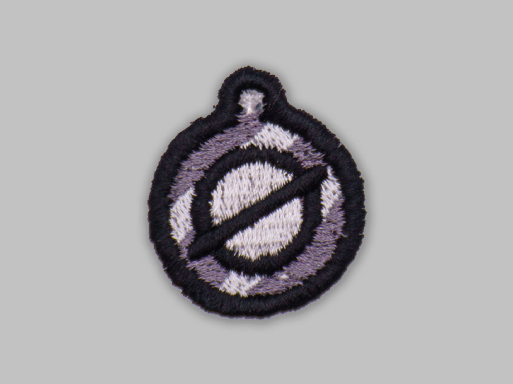 Circular patch with a design on a gray background